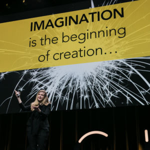 Kirryn in front of slide that says "Imagination is the beginning of creation"