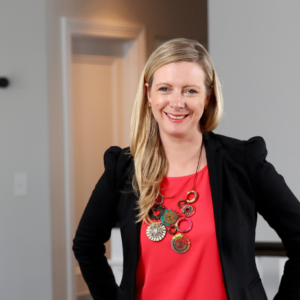 Photo of kirryn in orange top and black jacket smiling