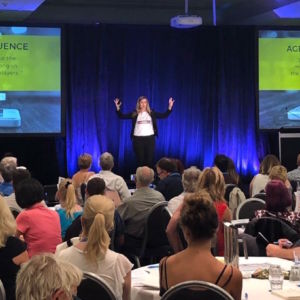 Kirryn ZErna on a stage with the slide saying Age of Online influence