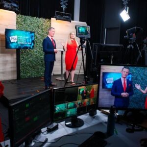 Kirryn stands on stage behind cameras