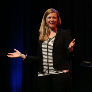 Kirryn zerna with hand out on stage